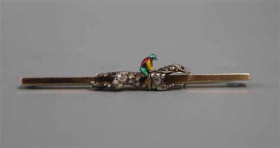 An early 20th century yellow metal, rose cut diamond and enamel set jockey & horse bar brooch, 53mm.